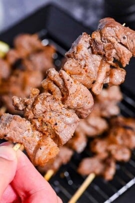 Beef Kushiyaki (Japanese Beef Skewers) served on a black rectangular plate with lemon wedges