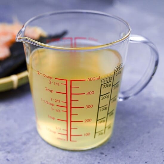 my favorite dashi in a glass measuring jug with gray background