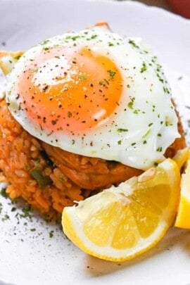 Japanese ketchup rice (chicken rice) topped with egg and served with lemon wedges