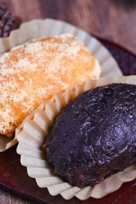 red bean and kinako ohagi on a red leaf-shaped plate