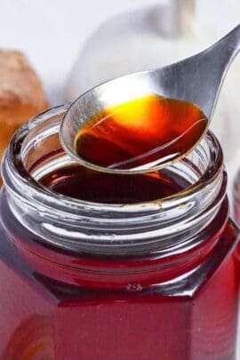 Homemade Japanese Rayu in a jar with a spoonful hovering above