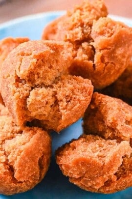 Sata Andagi Okinawan Donuts piled up on a blue plate
