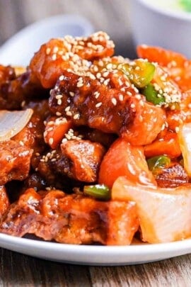 close up of subuta (Japanese sweet and sour pork) sprinkled with sesame seeds
