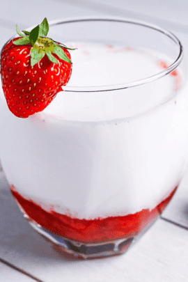 Japanese strawberry milk in a glass with a strawberry on the rim