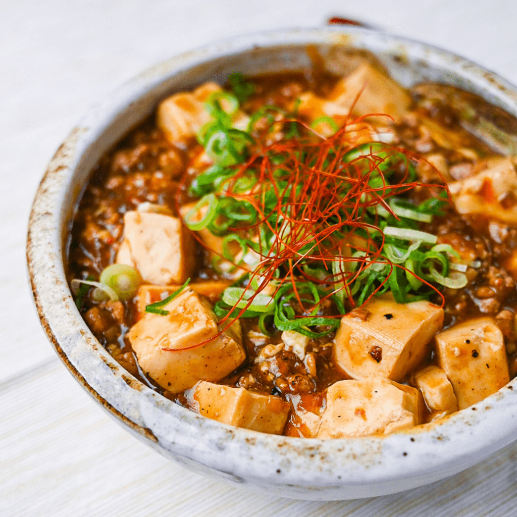 Japanese style mapo tofu topped with spring onion and chili threads
